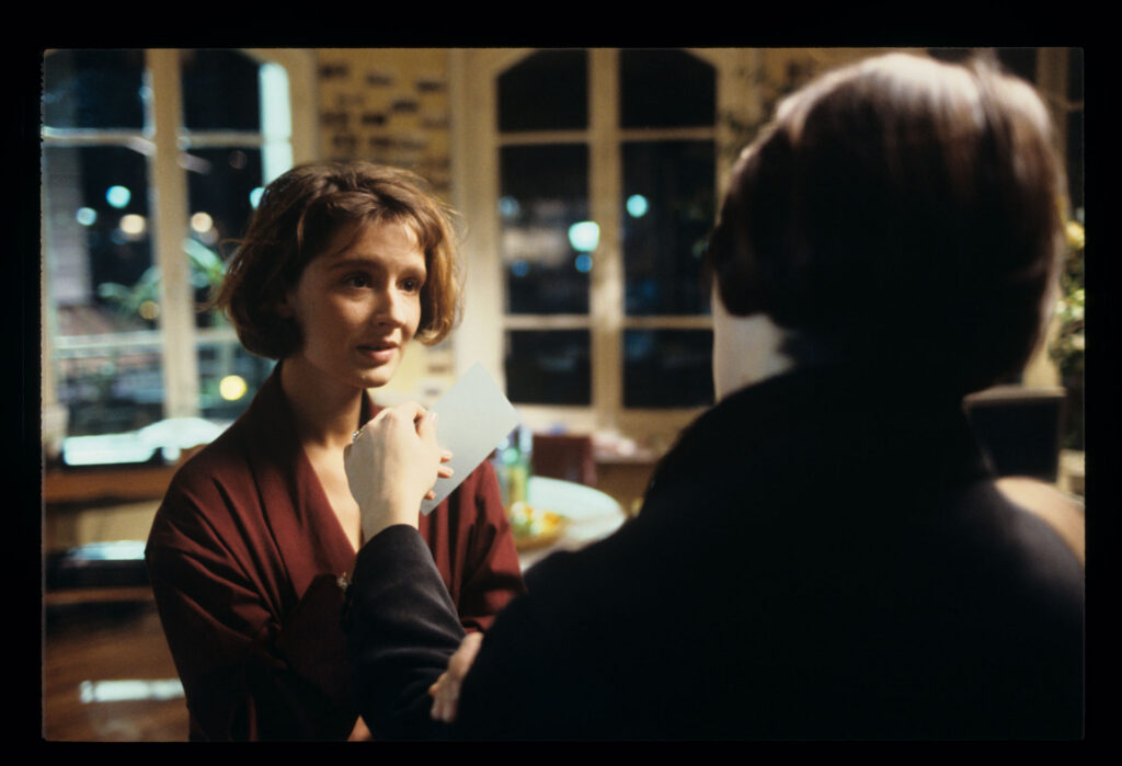 A copyist (Florence Vignon) in her apartment during a visit from Julie (Juliette Binoche).