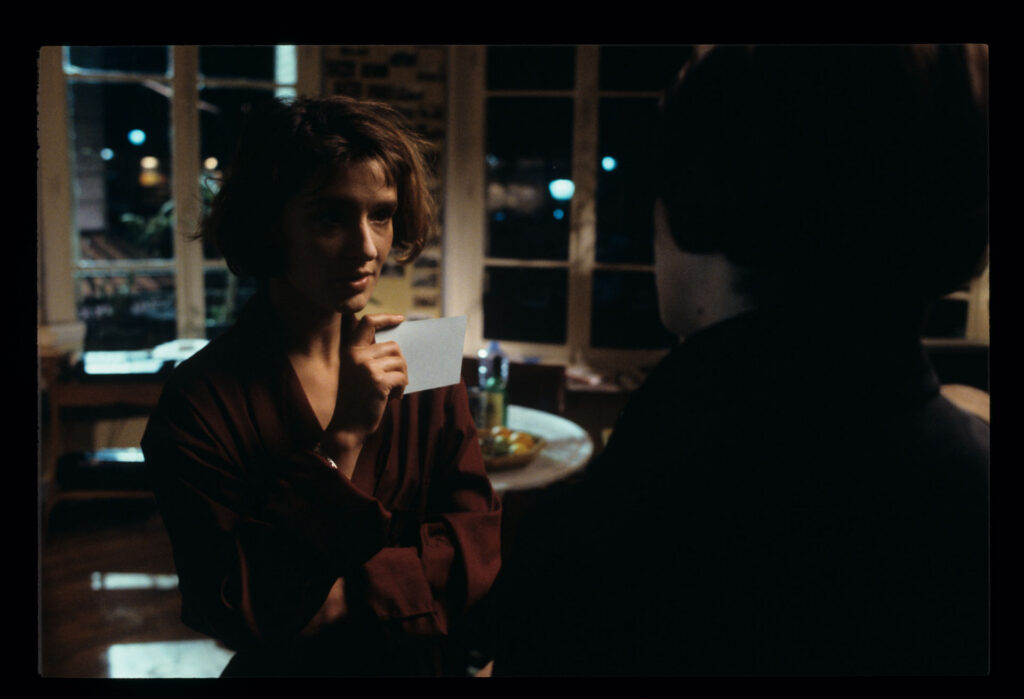 A copyist (Florence Vignon) in her apartment during a visit from Julie (Juliette Binoche).