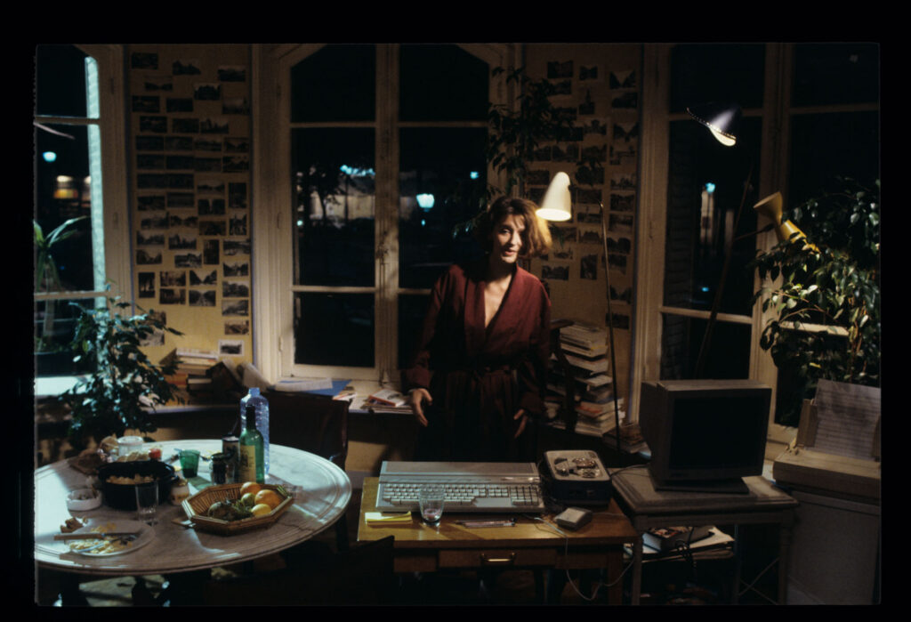 A copyist (Florence Vignon) in her apartment during a visit from Julie (Juliette Binoche).
