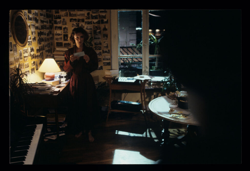 A copyist (Florence Vignon) in her apartment during a visit from Julie (Juliette Binoche).