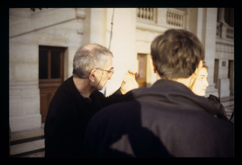 Krzysztof Kieślowski (director) during preparations for filming a scene in the corridor of the Paris Palace of Justice.