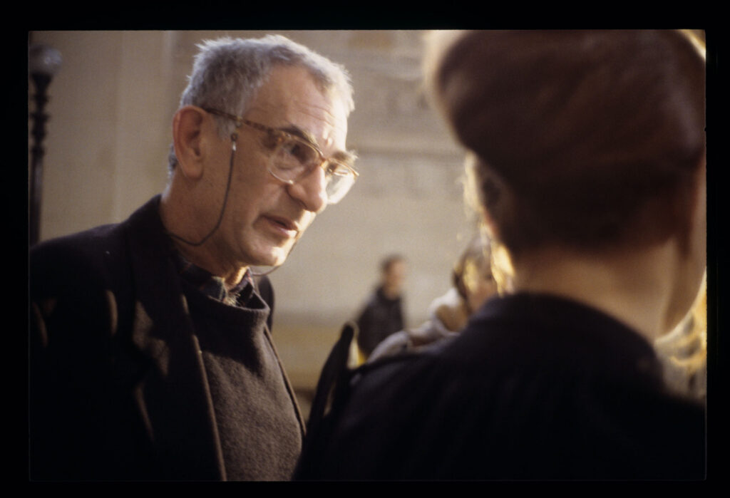 Krzysztof Kieślowski (director) during preparations for filming a scene in the corridor of the Paris Palace of Justice.