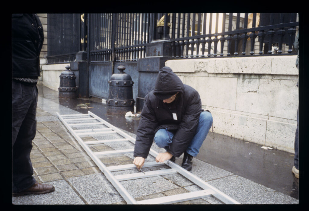 Krzysztof Kieślowski (director) with a ladder while preparing for the scene in front of the courthouse