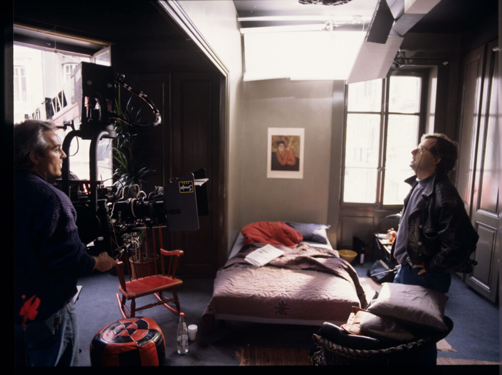 Piotr Sobociński (cinematographer) and a member of the lighting crew prepare to film a shot in Valentine's apartment.