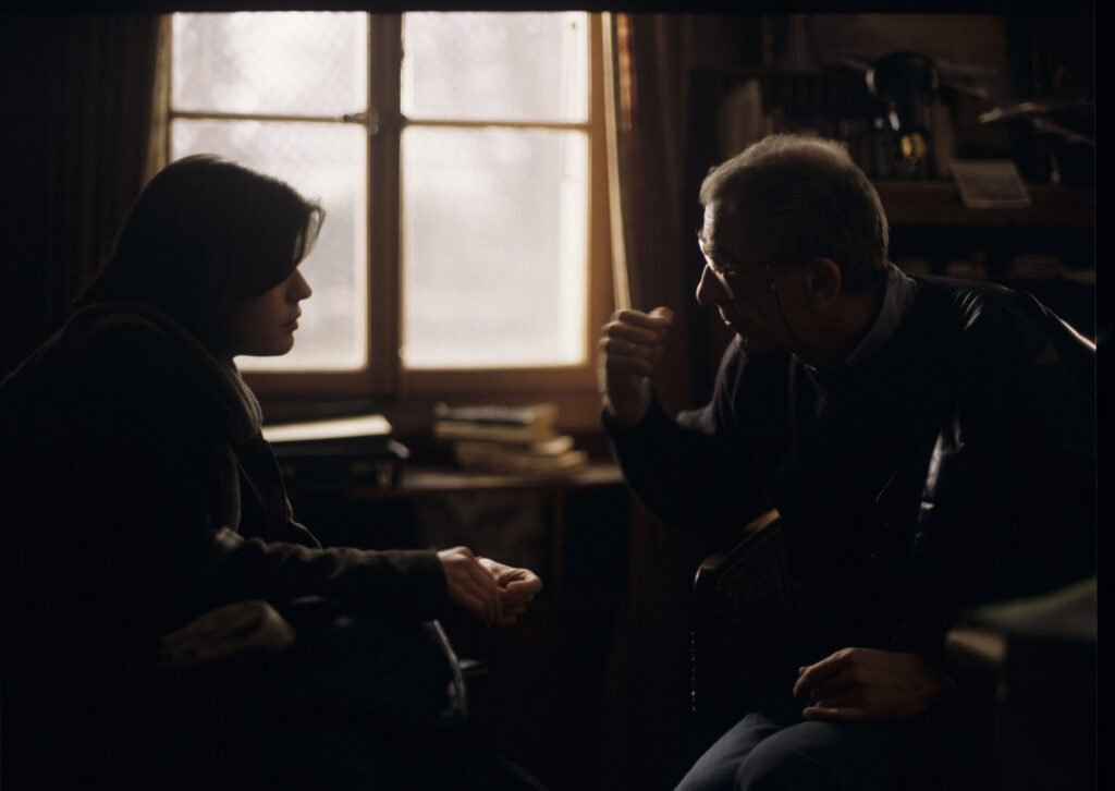 Kieślowski (director) gives instructions to actress Jacob (actress) on the set in the judge's apartment.