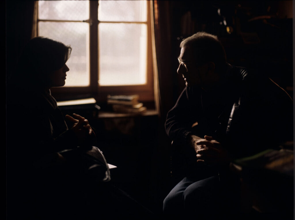 Kieślowski (director) gives instructions to actress Jacob (actress) on the set in the judge's apartment.