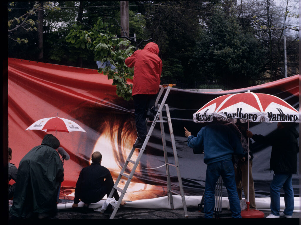 The film crew assembling an advertising billboard with the image of Valentine - the main character of the film.