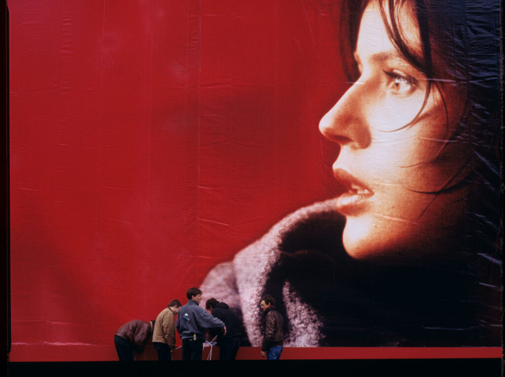 The film crew assembling an advertising billboard with the image of Valentine - the main character of the film.