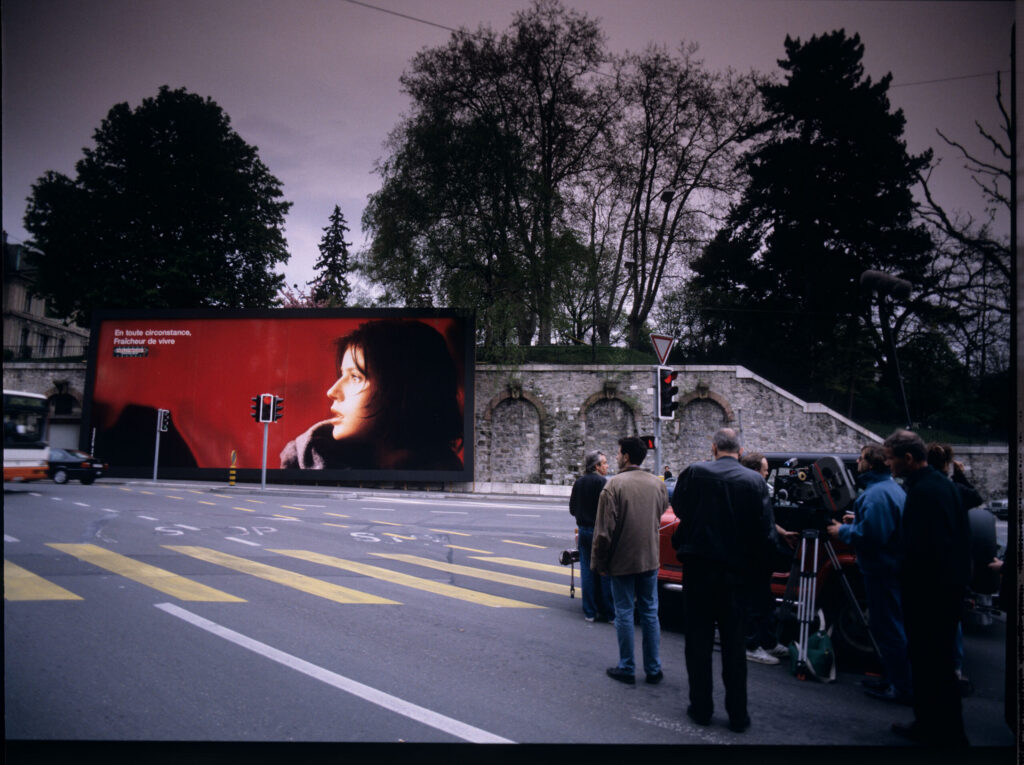 The crew on set on a Geneva street, where a billboard with Valentine's image was hung.
