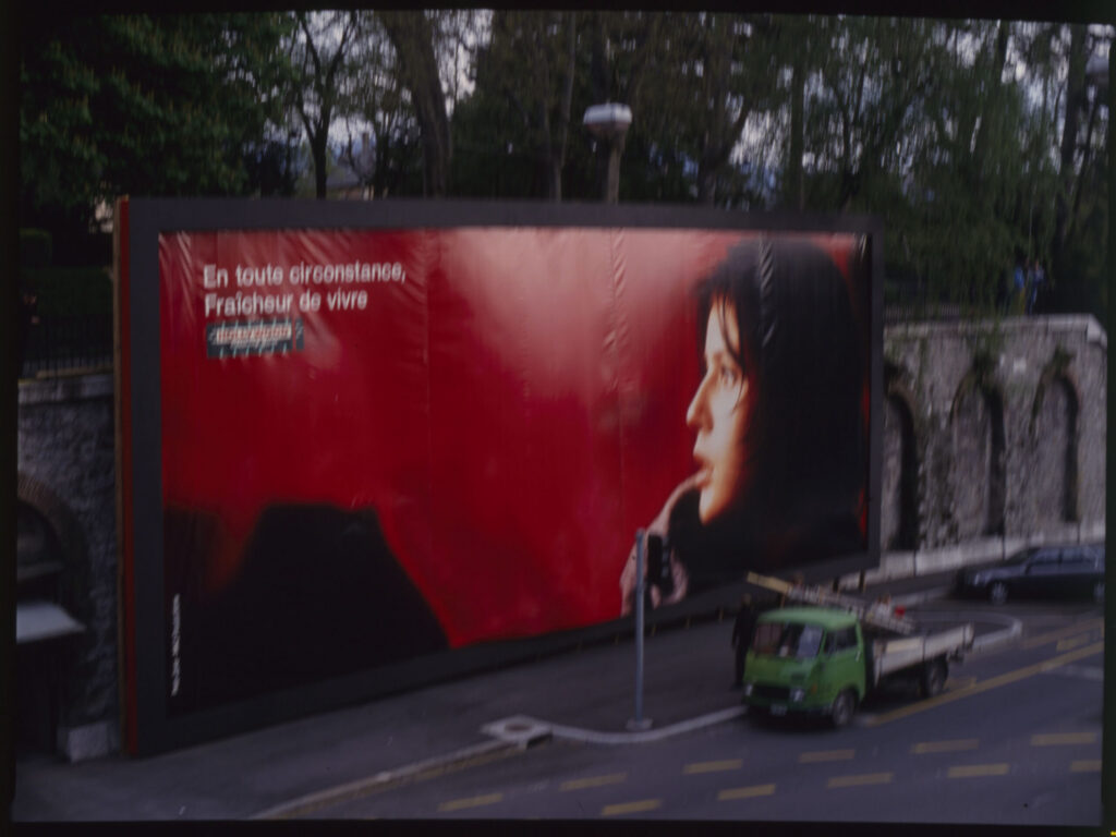 Preparations for the dismantling of an advertising billboard on a Geneva street.