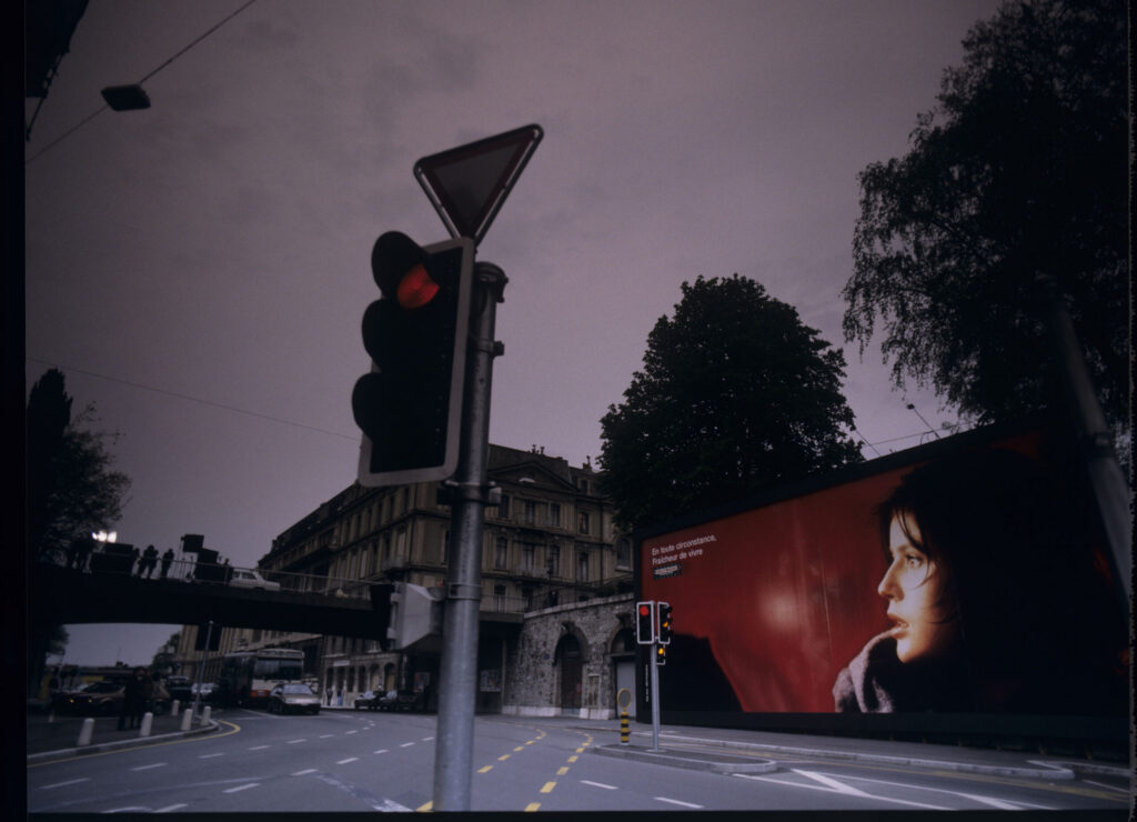 An advertising billboard on a Geneva street with an image of Valentine - the main character played by Irène Jacob.