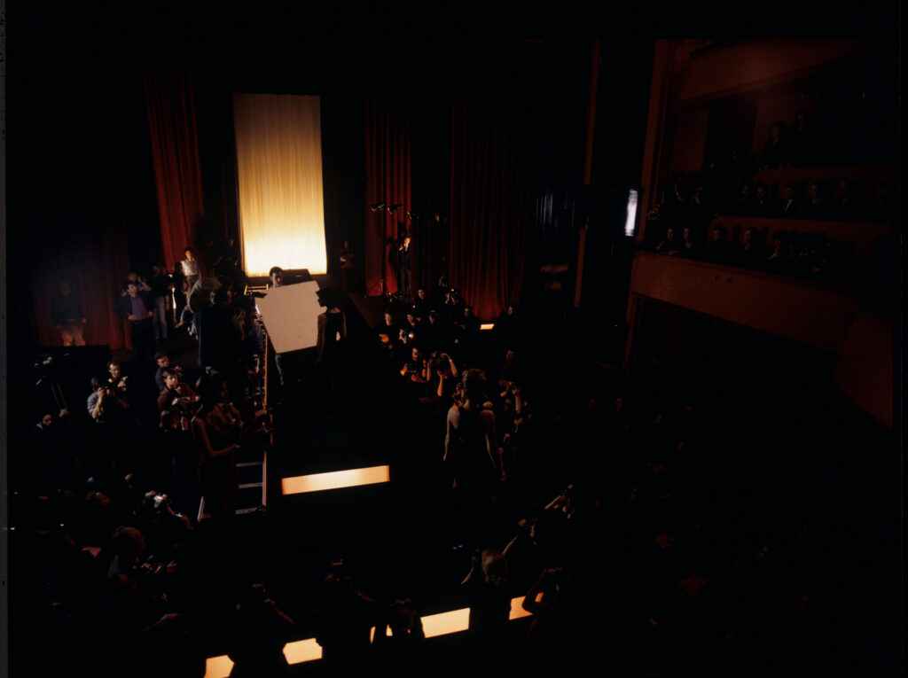 Filming a fashion show scene at the theater featuring Valentine. Actress Irène Jacob as Valentine on the set.