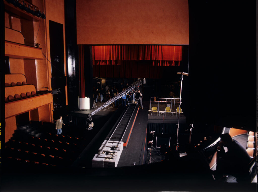 The crew working on the set during preparations for the fashion show scene featuring Valentine as a model.