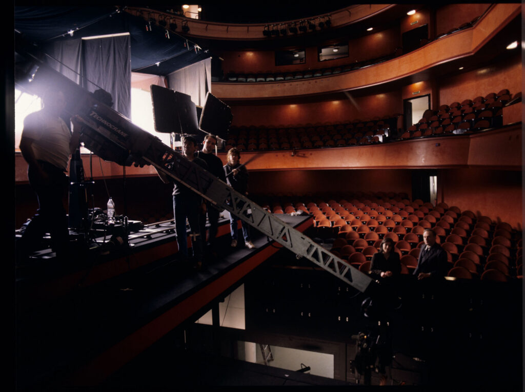 Crew on set at the theater during filming of the meeting scene between Valentine and the judge. Film crew visible.