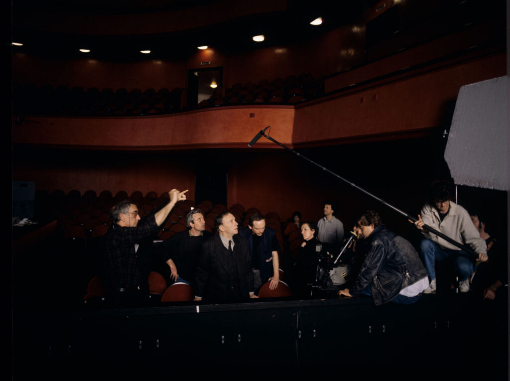 Crew on set at the theater during filming of the meeting scene between Valentine and the judge. Film crew visible.
