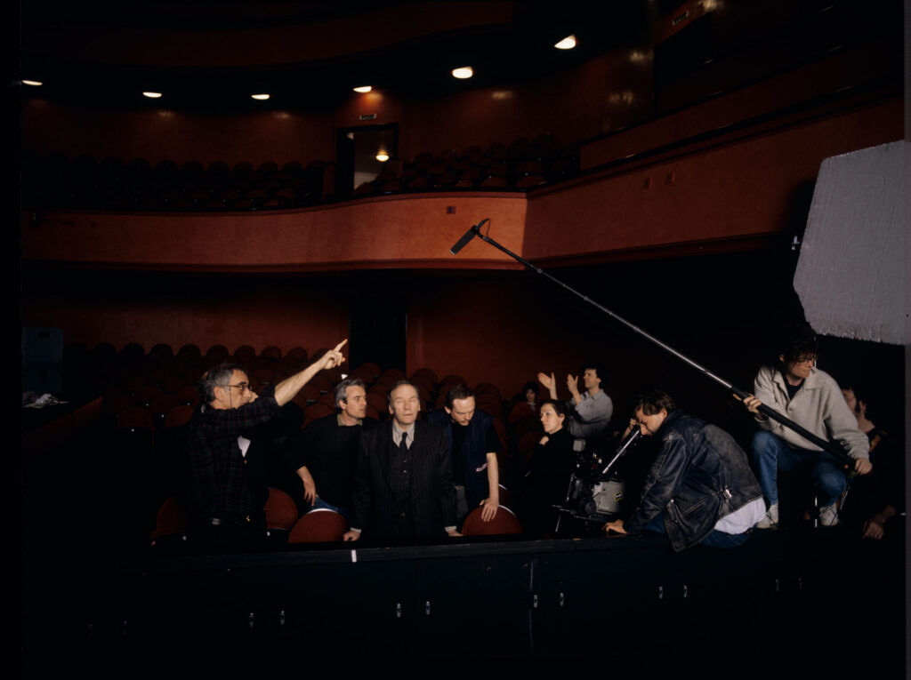 Crew on set at the theater during filming of the meeting scene between Valentine and the judge. Film crew visible.